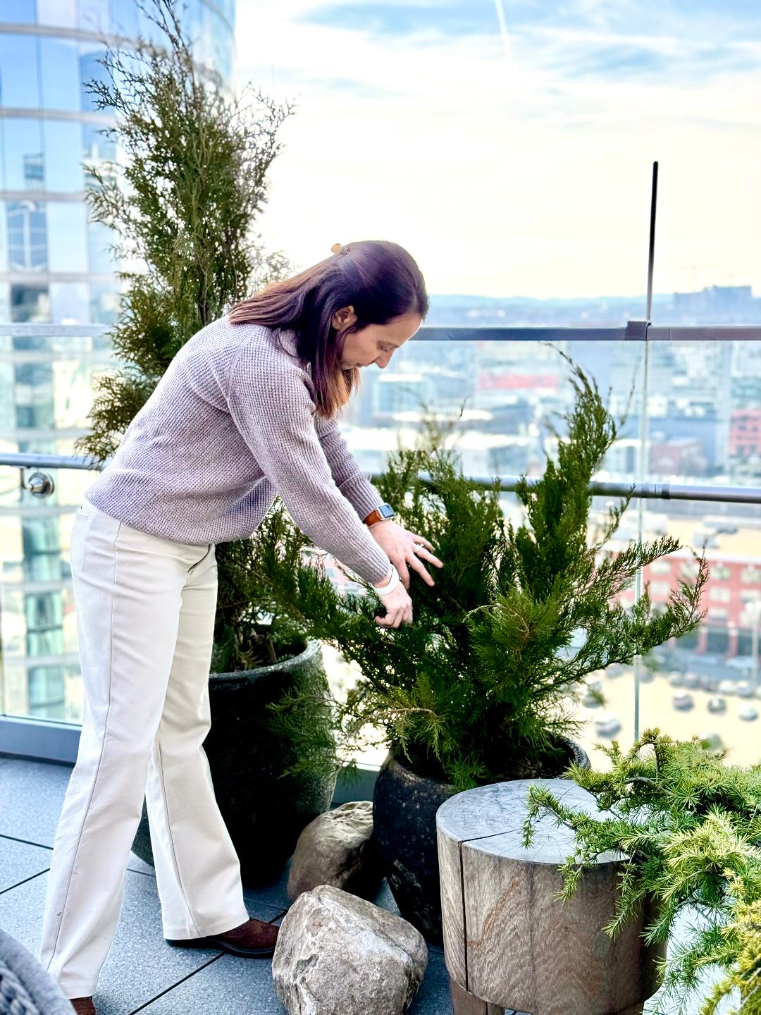 Megan McDugald caring for plants on a Rooftop Deck in Downtown Nashville Tennessee
